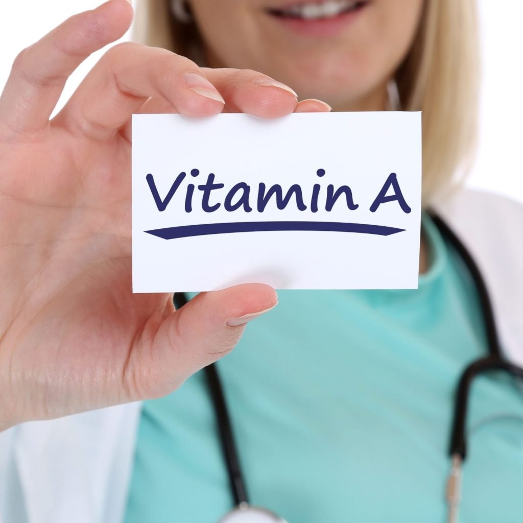 A Doctor is holding a picture that signifies the importance of keeping your vitamin A levels in good measure in order to cure vitamin A deficiency.