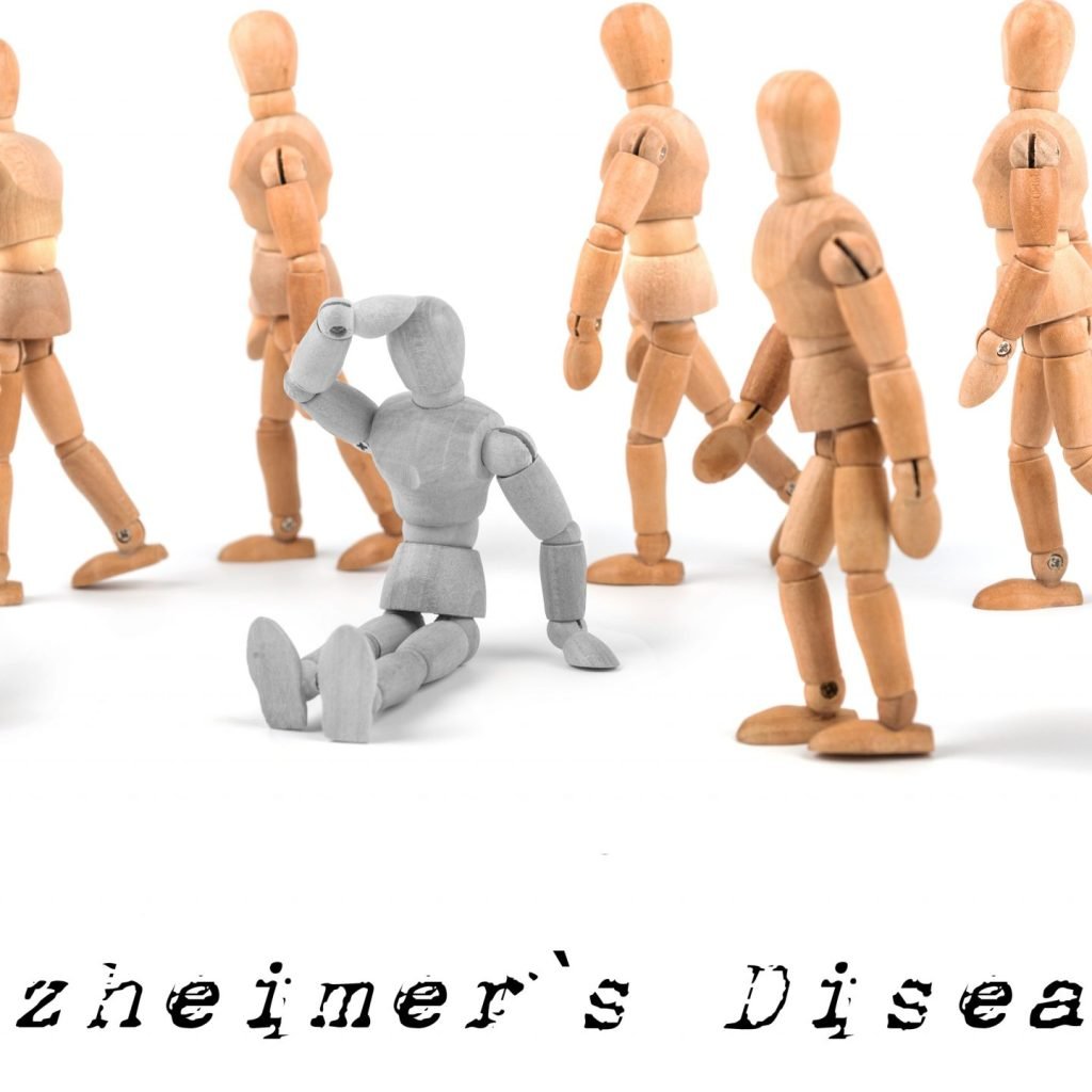 Alzheimer's disease concept - wooden mannequin sitting confused in waking group.