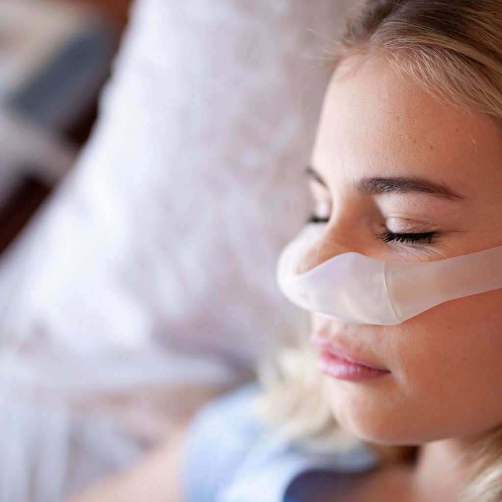 An Image of a patient sleeping with a CPAP machine for sleep apnea.