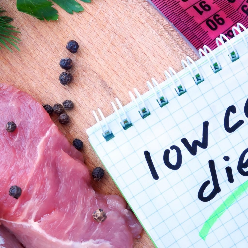 A scribble pad on which is written the phrase "Low-Carb Diet".