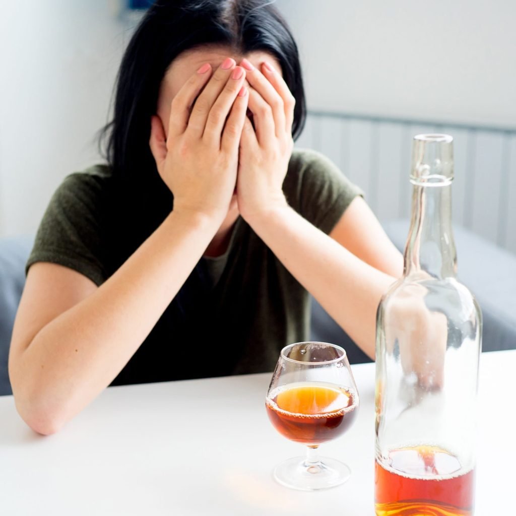 A young woman suffering from alcohol addiction.