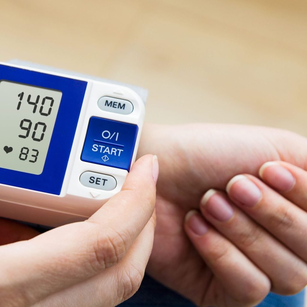 A woman checking to see if she has high blood pressure.