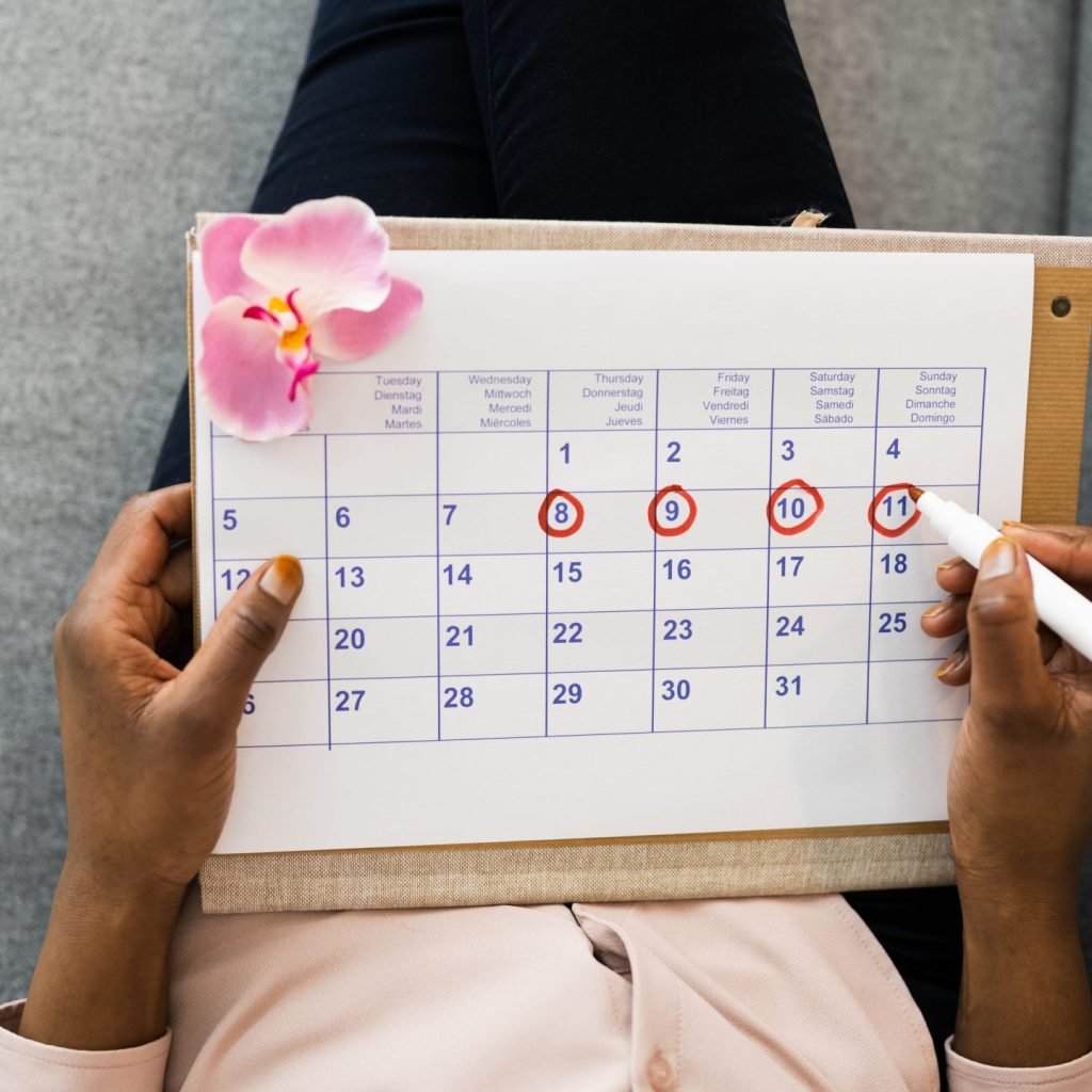 A woman seen using her menstrual cycle calendar.