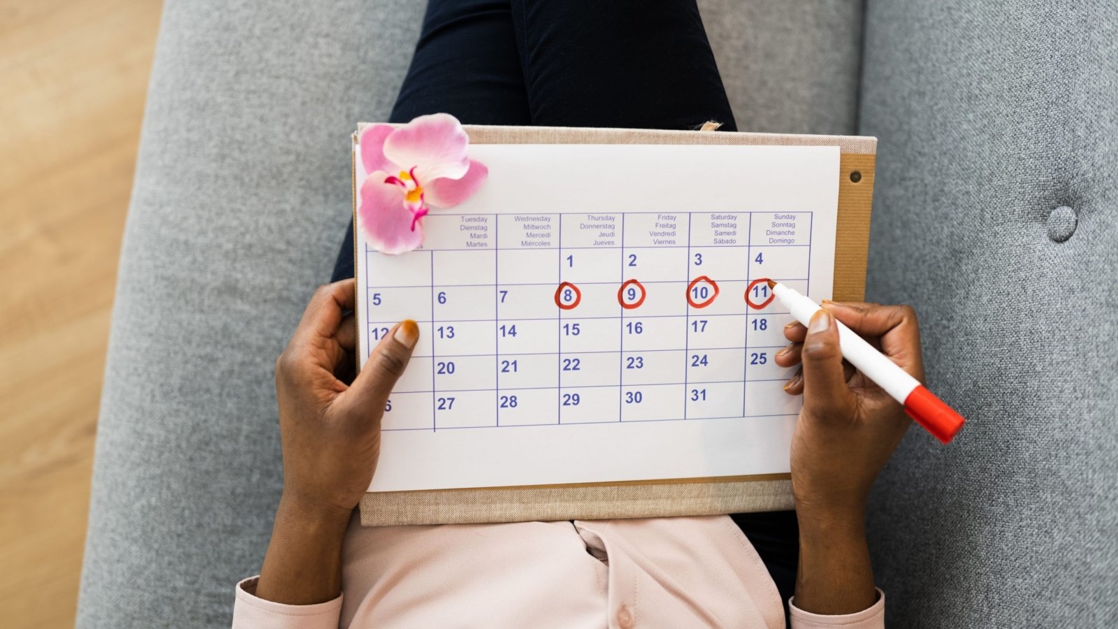 A woman seen using her menstrual cycle calendar.