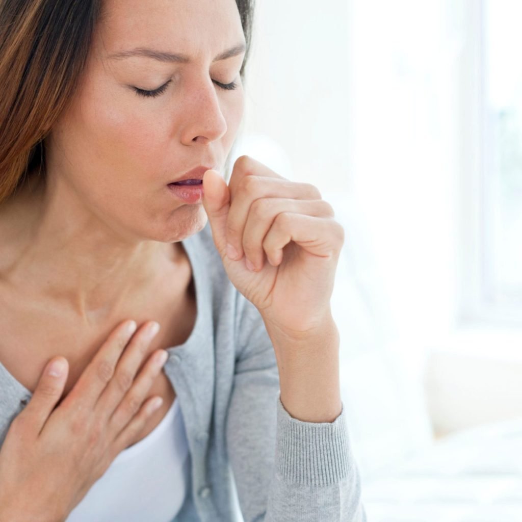 A young woman suffering from persistent cough.