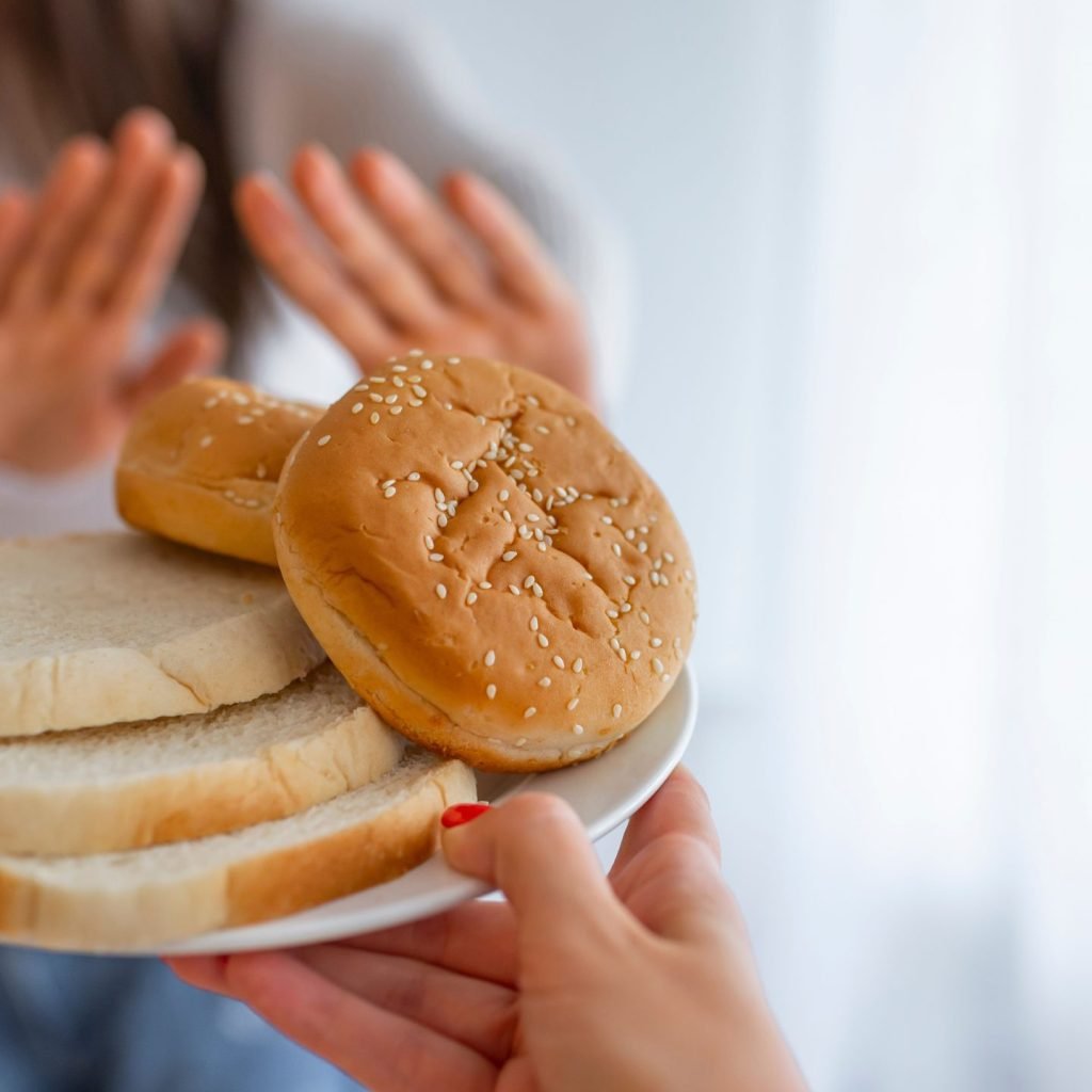 Hands of a woman gesturing a big No to foods containing Gluten for fear of Gluten Intolerance.