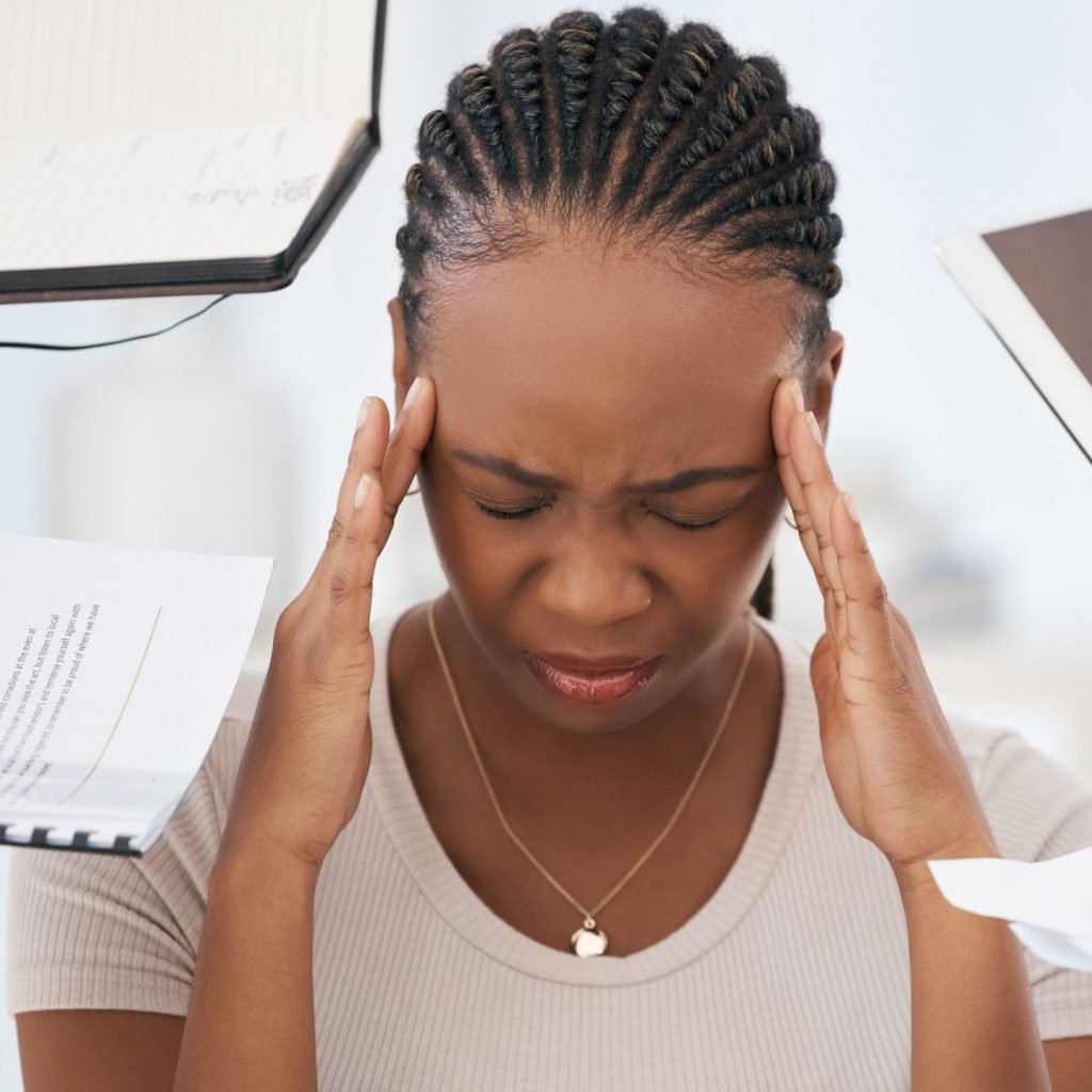 A woman displaying indications of job stress, a thing on which scientific evidence mounts as to how affects interpersonal relationships in the workplace.