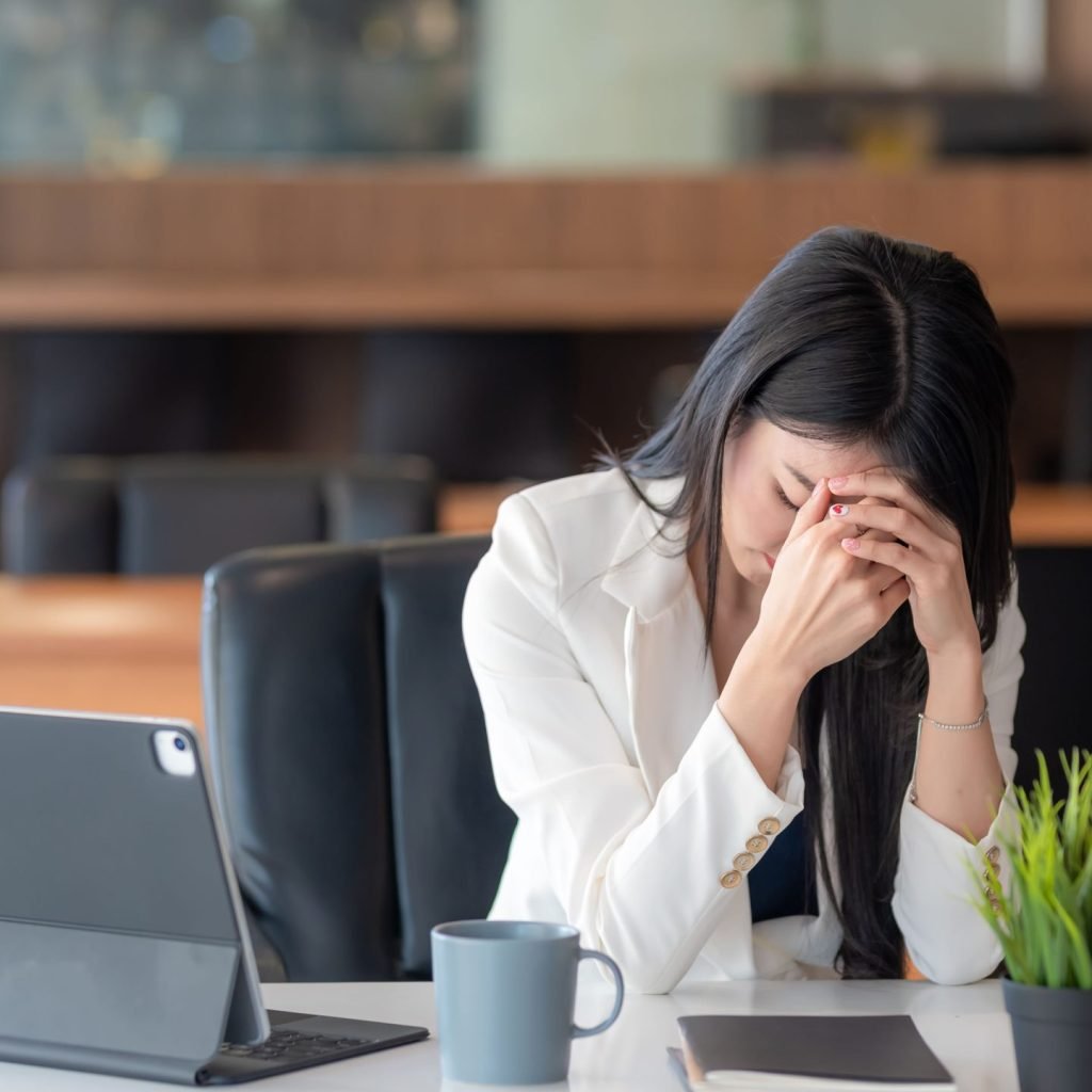 A woman is seen suffering the effects of workplace anxiety.